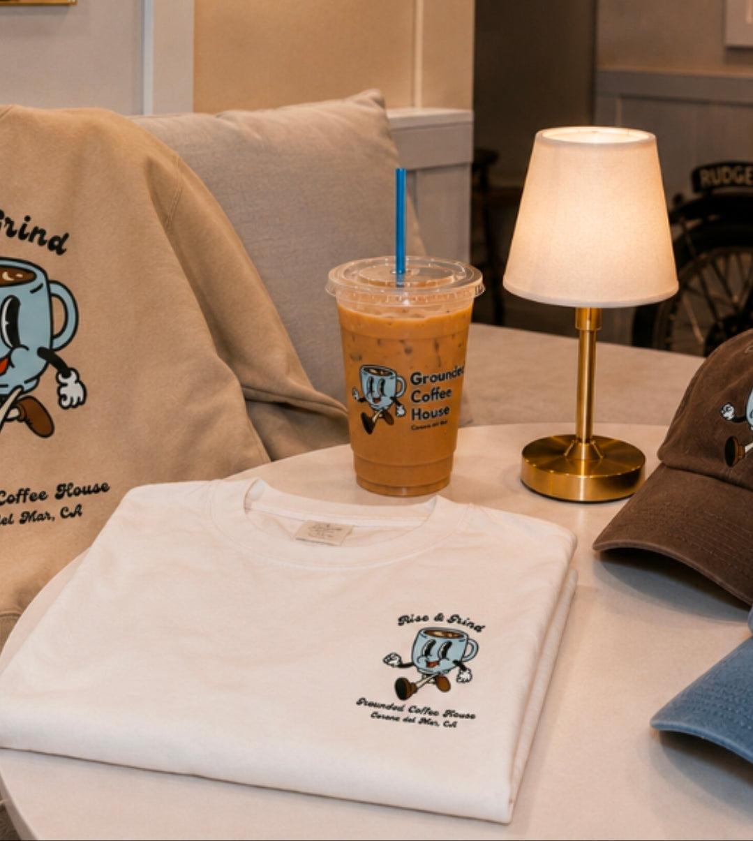 The Grounded Tee in sand color — Grounded Coffee House coffee shop apparel, flat lay